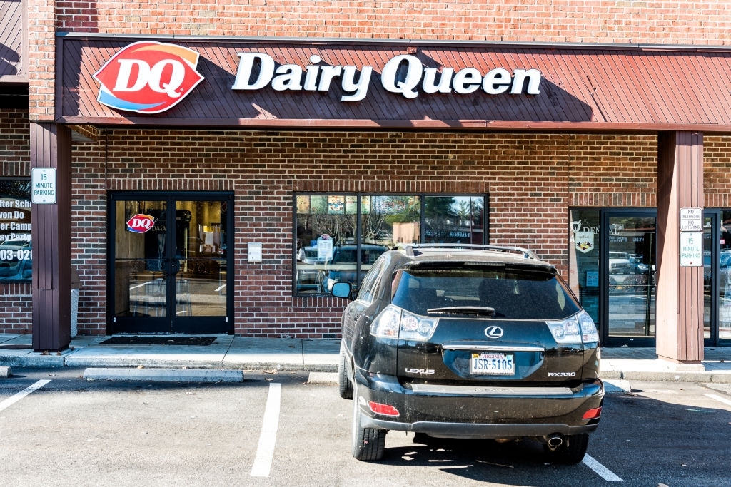 Dairy Queen fast food restaurant ice cream store in plaza shopping center strip mall sign in Virginia with parking lot, shops
